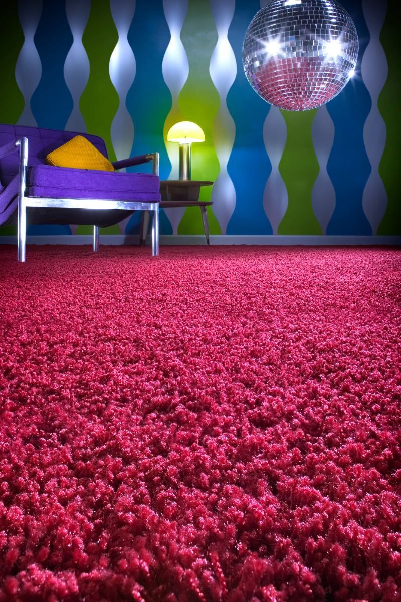 A living room with a disco ball hanging from the ceiling