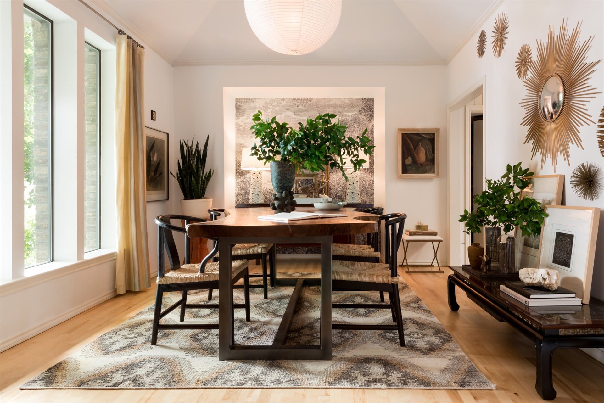 A dining room with a table and chairs and a rug