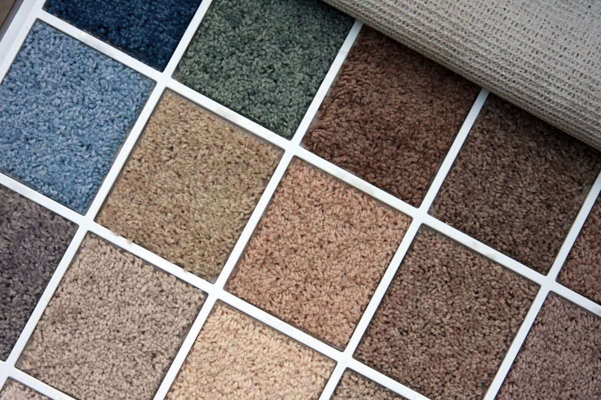 A bunch of different colored squares of carpet on a table