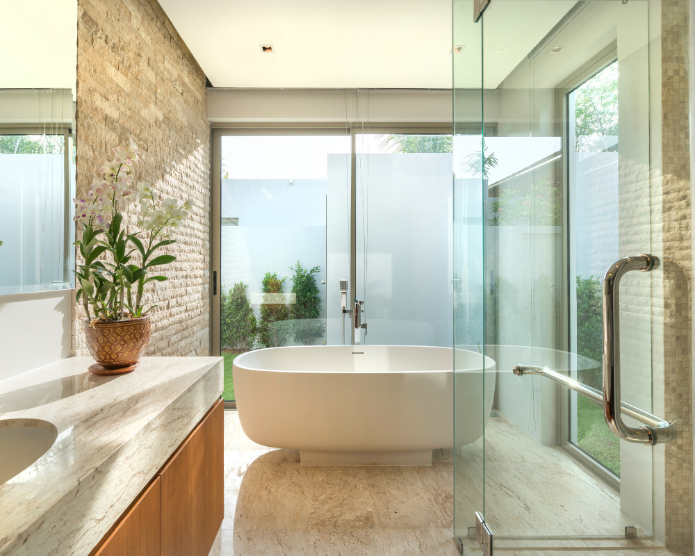 A bathroom with a tub , sink , mirror and sliding glass doors Menke Inc. Abilene, TX