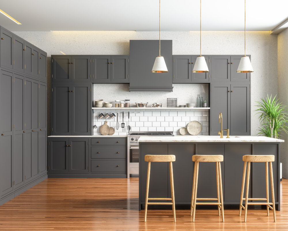 A modern kitchen with gray cabinets , wooden floors , stools and a large island. Menke Inc. Abilene, TX