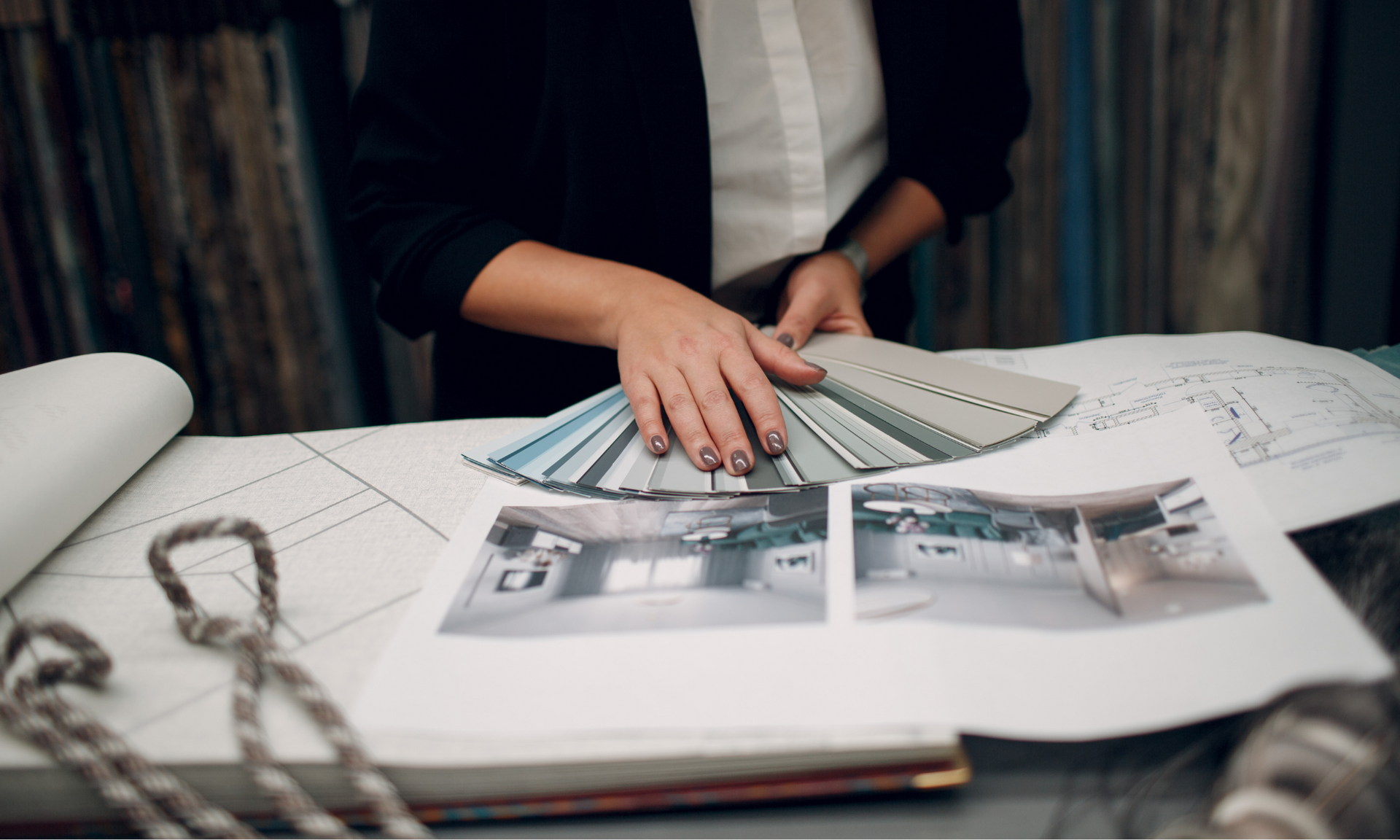 A woman is sitting at a table looking at fabric samples. Menke Inc. Abilene, TX