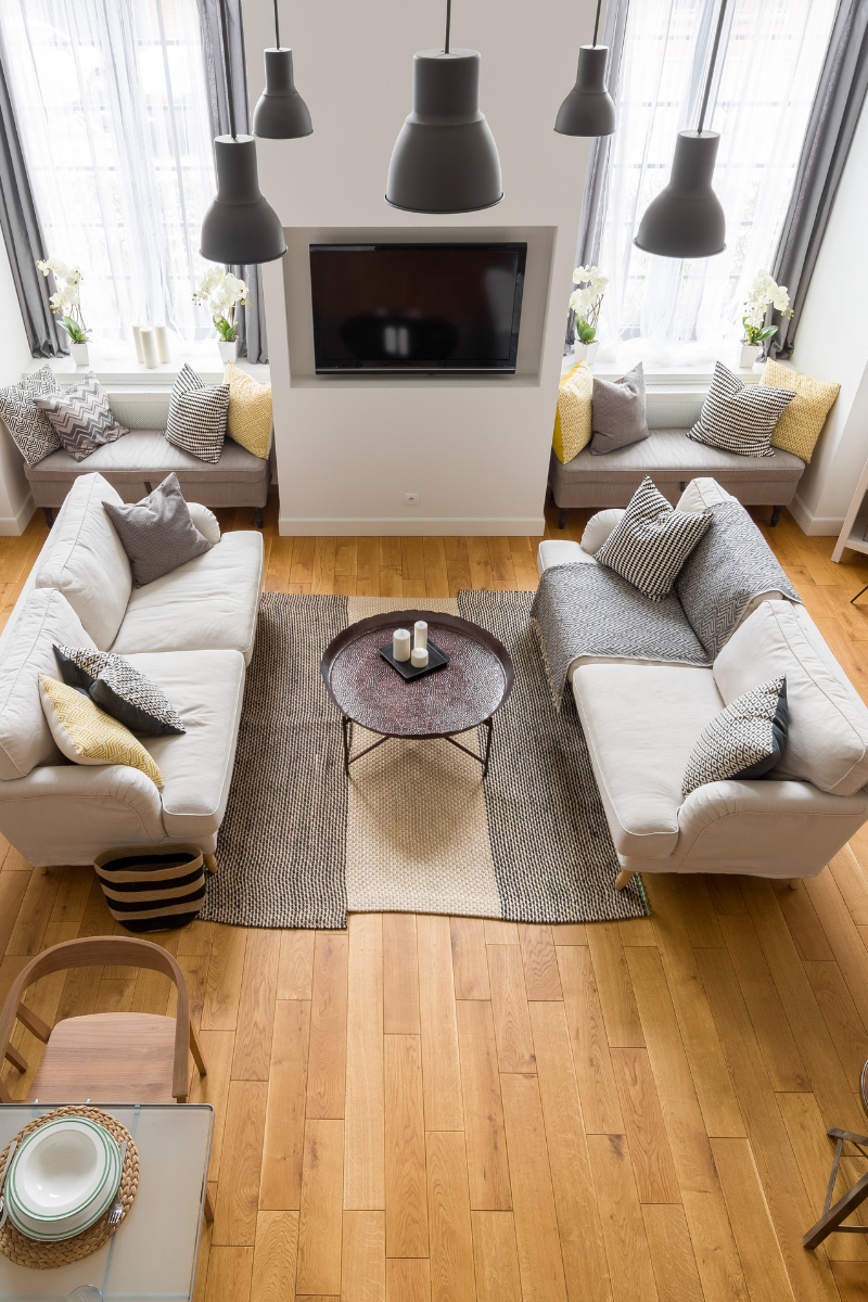 A living room with two couches , a coffee table , and a flat screen tv.