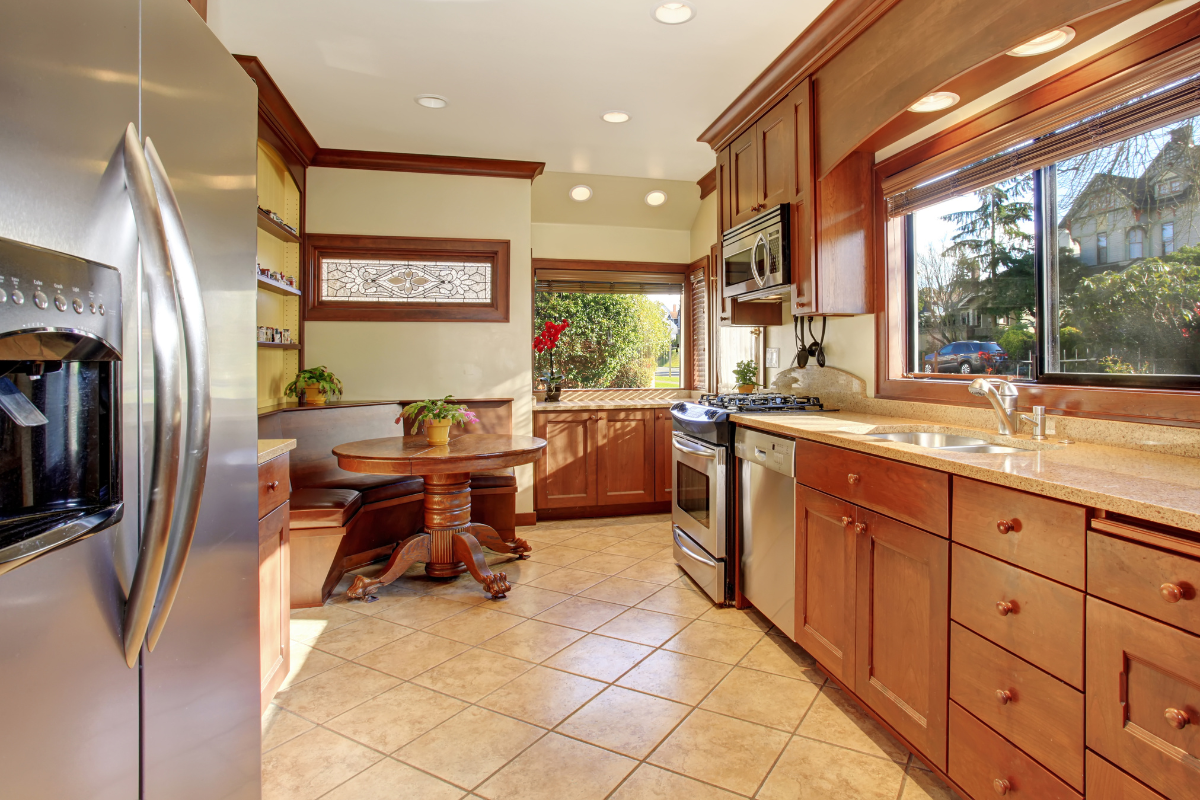 A kitchen with stainless steel appliances and wooden cabinets. Menke Inc. Abilene, TX
