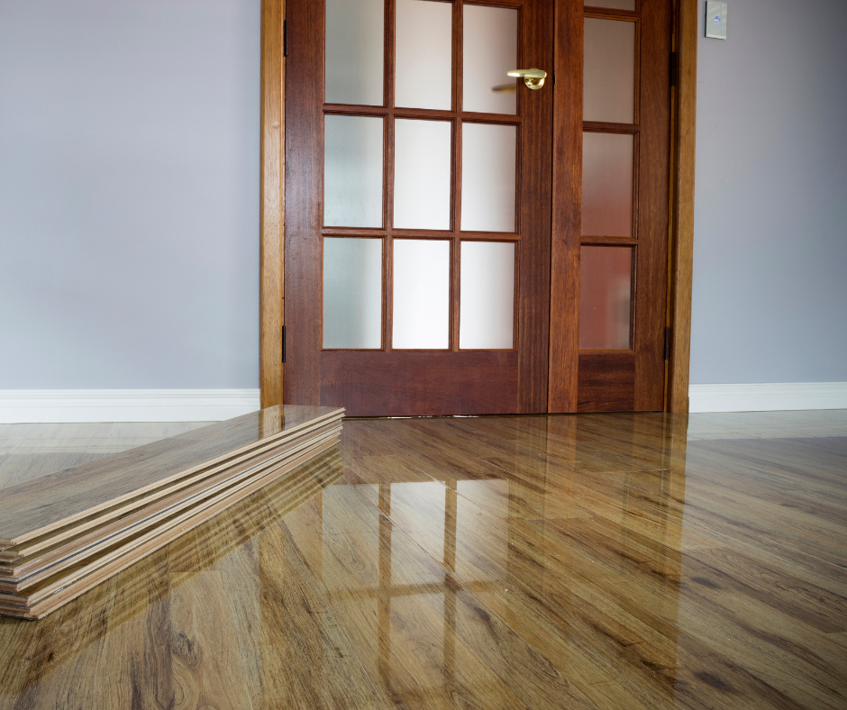A wooden door with a reflection of the door in the floor
