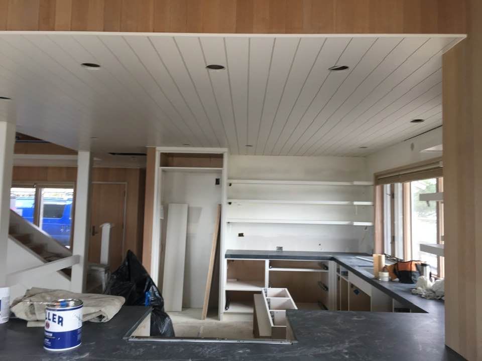 A bottle of paint sits on a counter in a kitchen