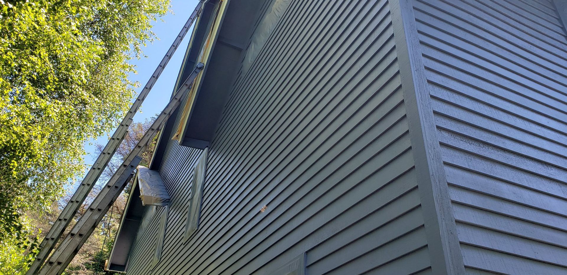 A close up of a house with a ladder on the side of it.