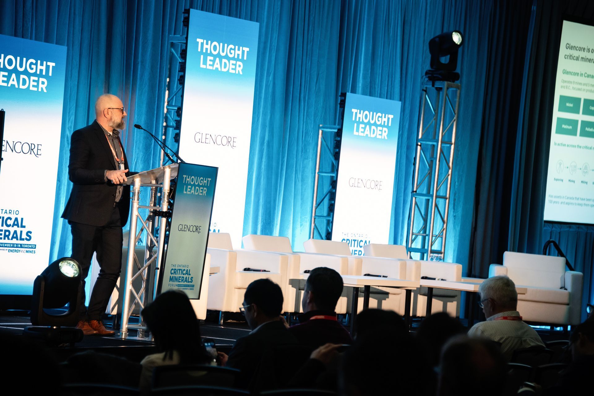 Man speaking at a conference. Stage with