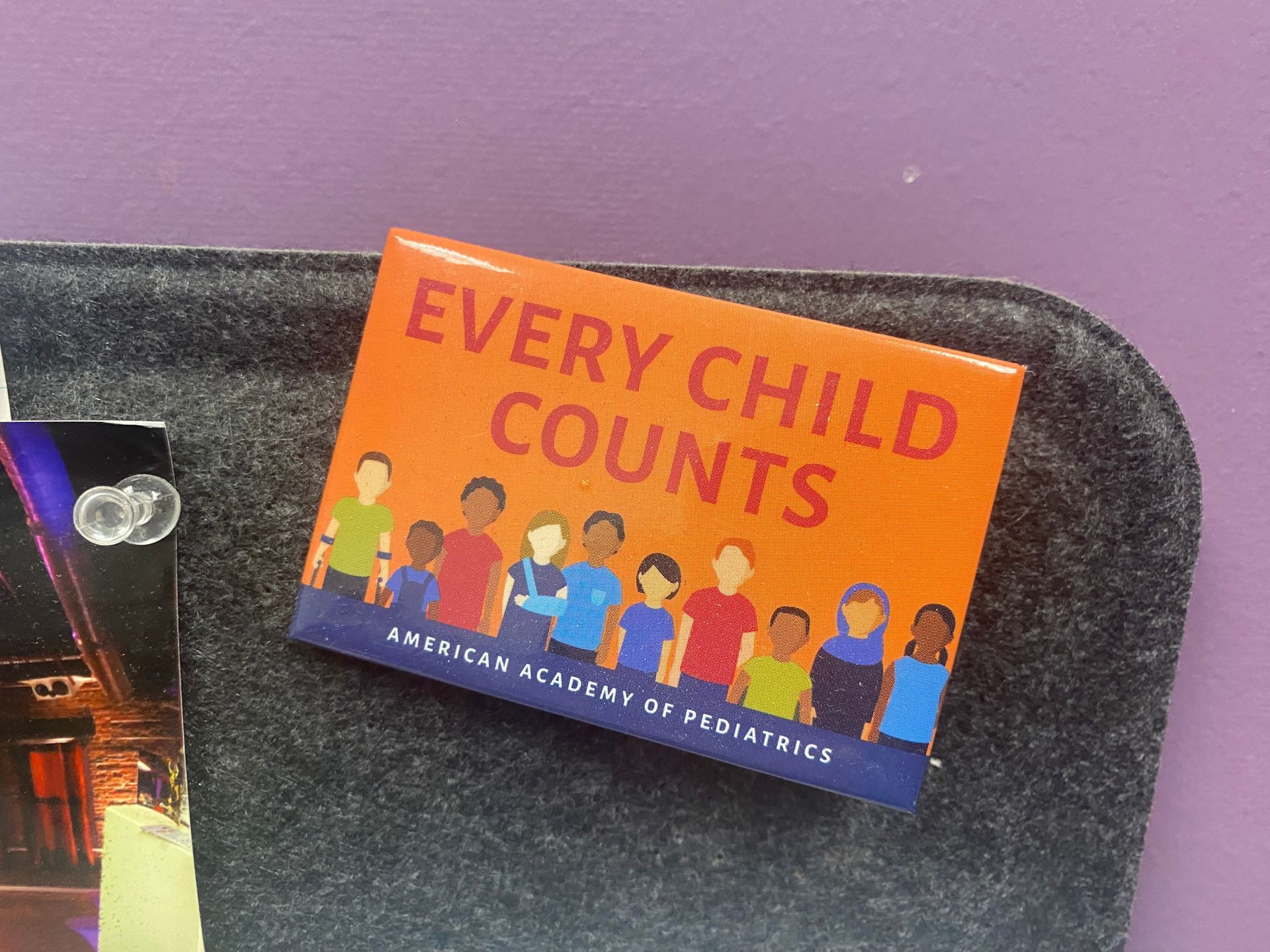 A pin that says every child counts on it