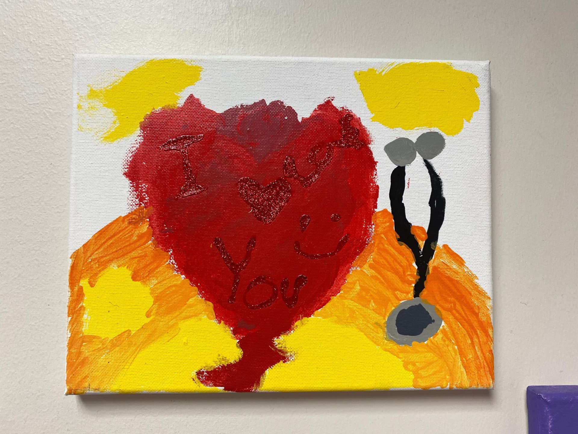 Painting of a heart next to a pediatrician's stethoscope