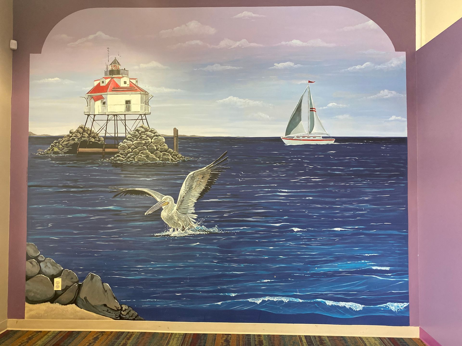 Painting of a lighthouse at the ocean