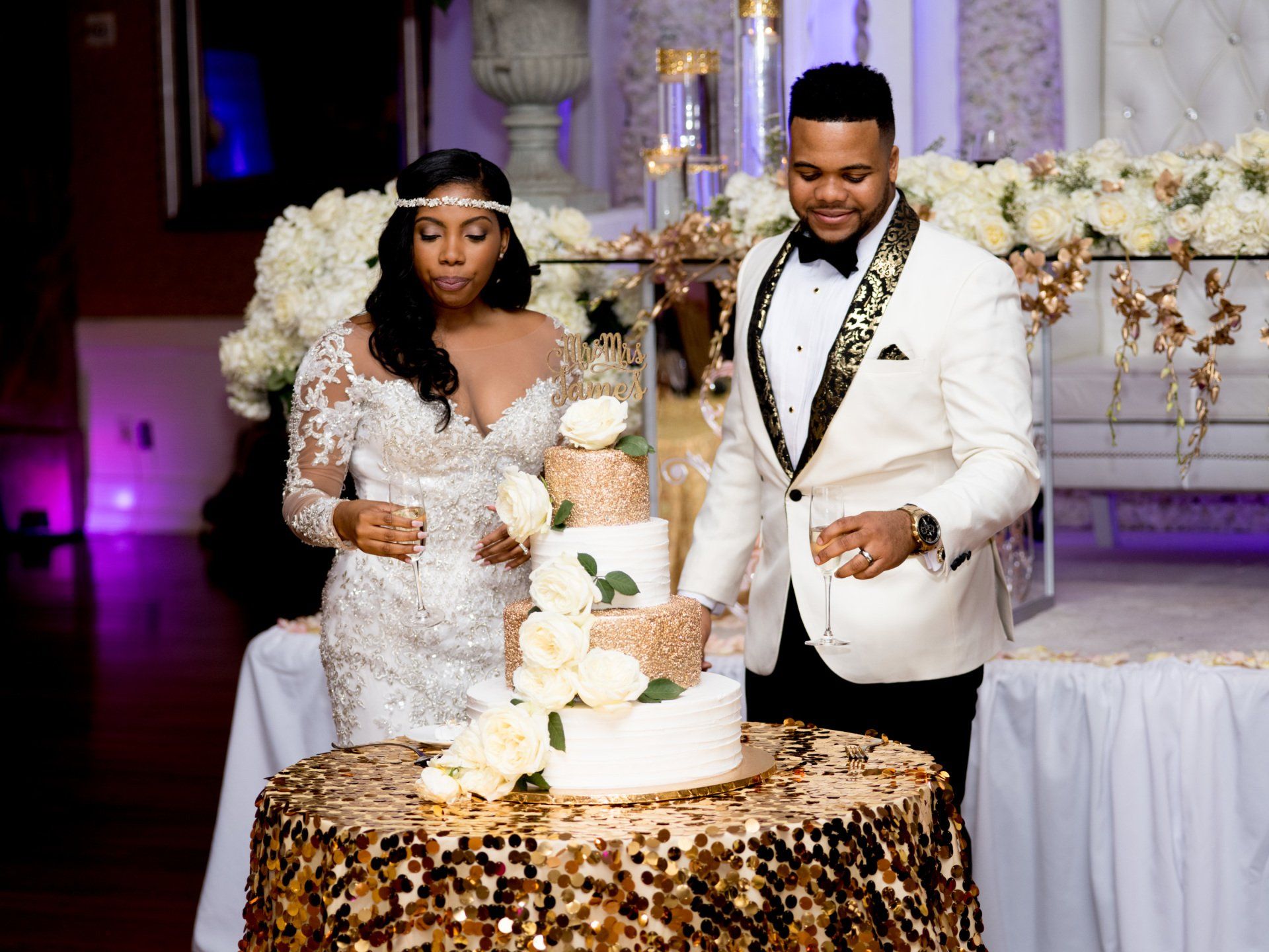 A bride and groom are cutting their wedding cake.