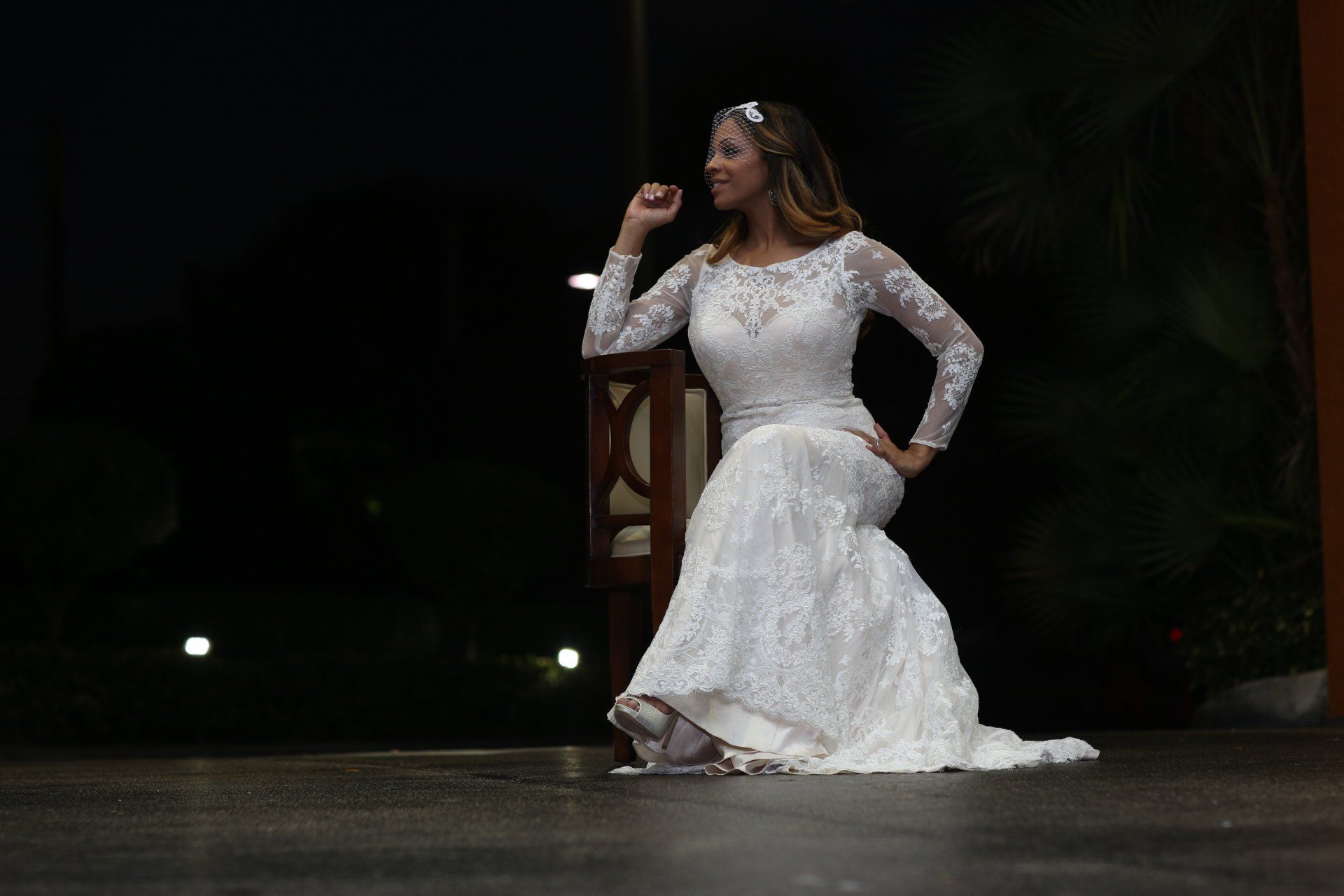 A woman in a wedding dress is dancing on a stage.