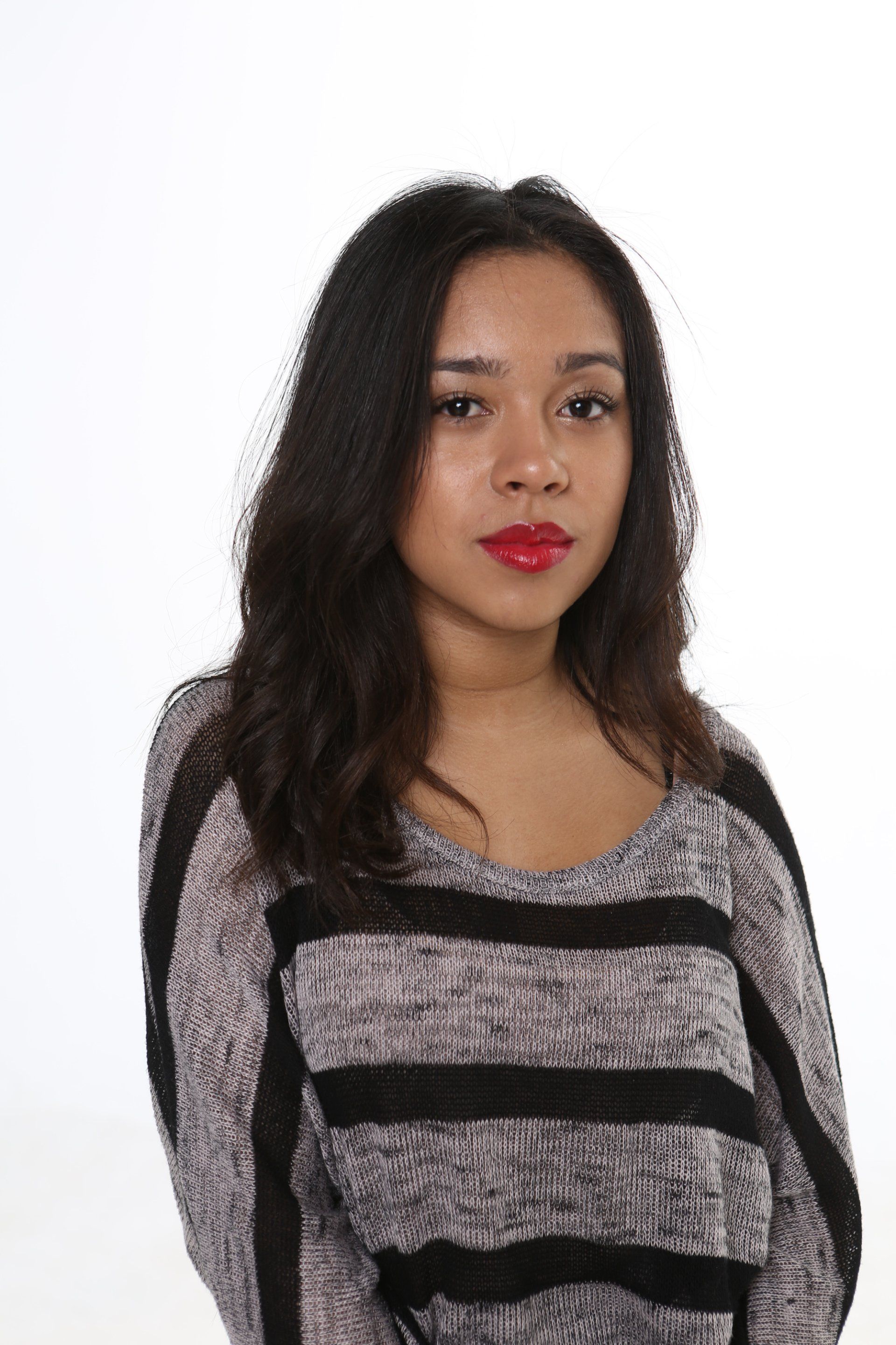The woman is wearing a striped sweater and red lipstick