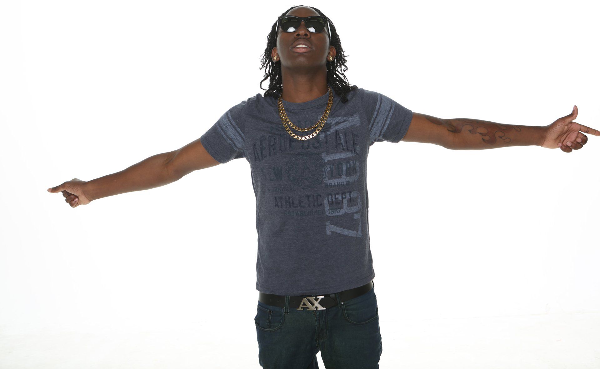 A man with his arms outstretched wearing a t-shirt with the number 1937 on it