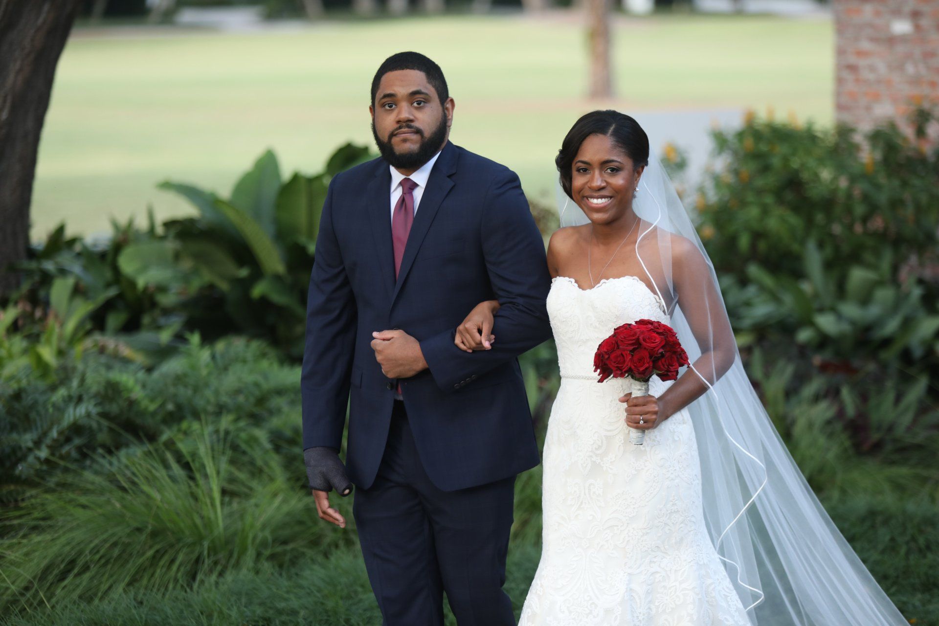 A bride and groom are posing for a picture on their wedding day.