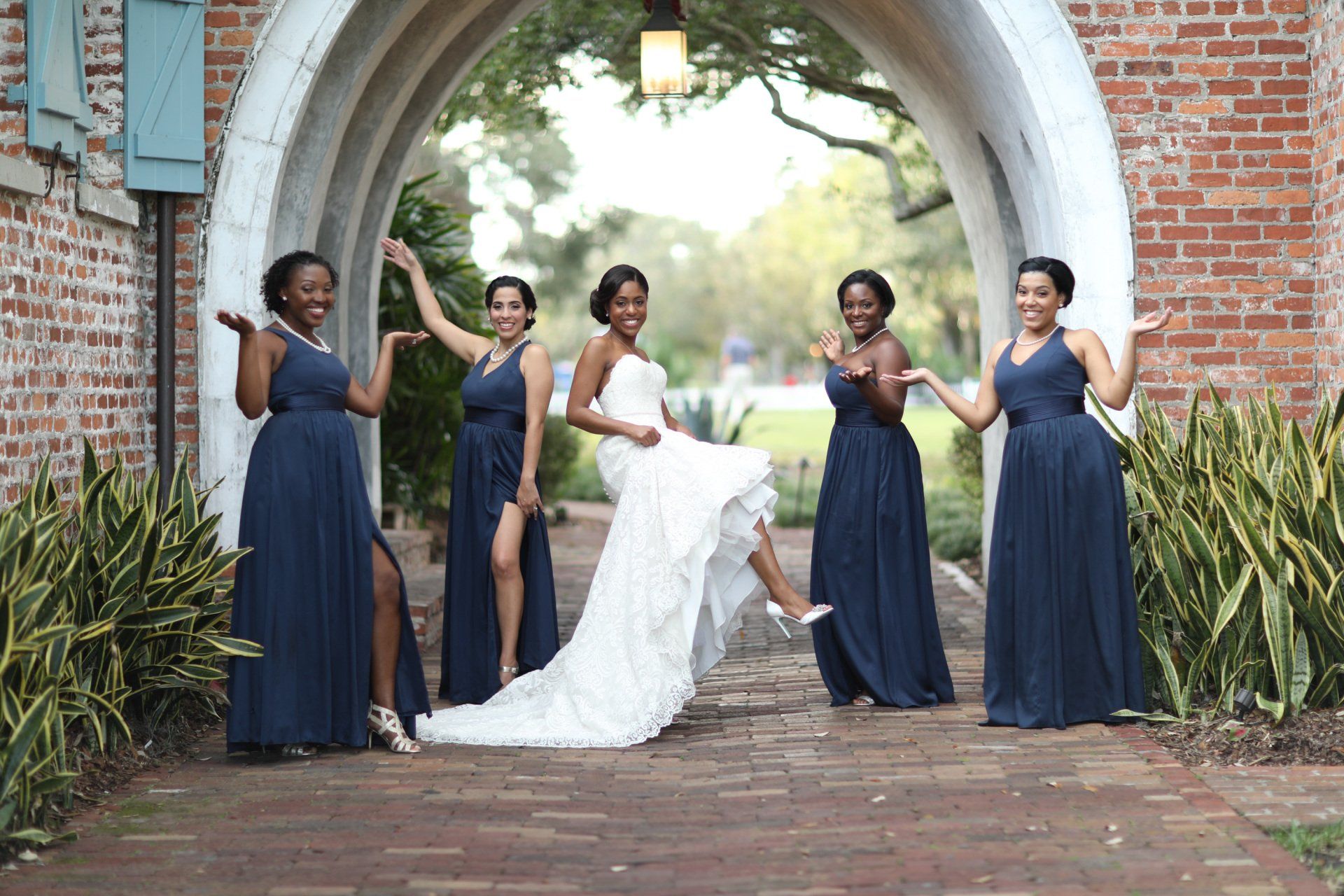 A bride and her bridesmaids are posing for a picture.