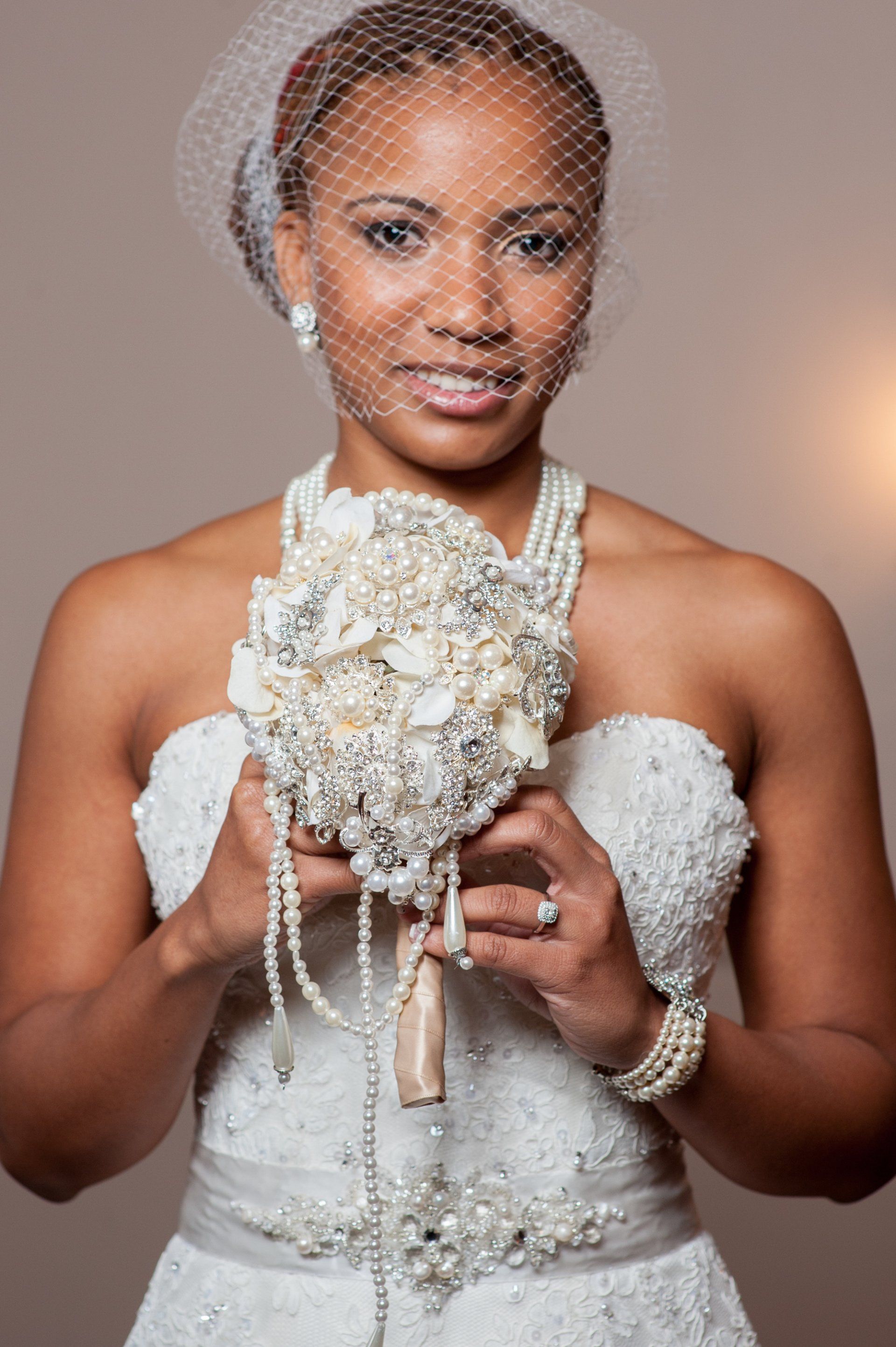 A woman in a wedding dress is holding a bouquet of flowers.