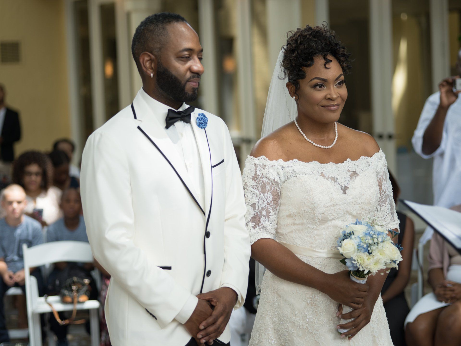 A bride and groom are standing next to each other at their wedding ceremony.