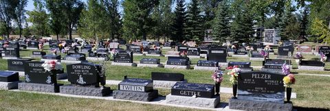 A cemetery filled with lots of graves and flowers