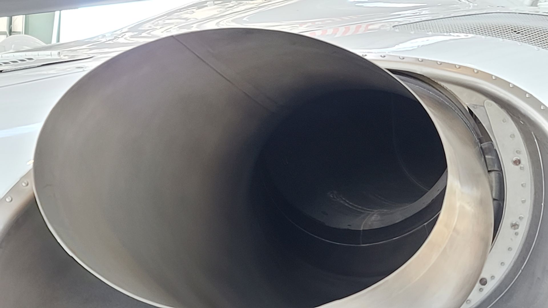 Jet engine exhaust nozzle, dark interior with a metallic exterior.