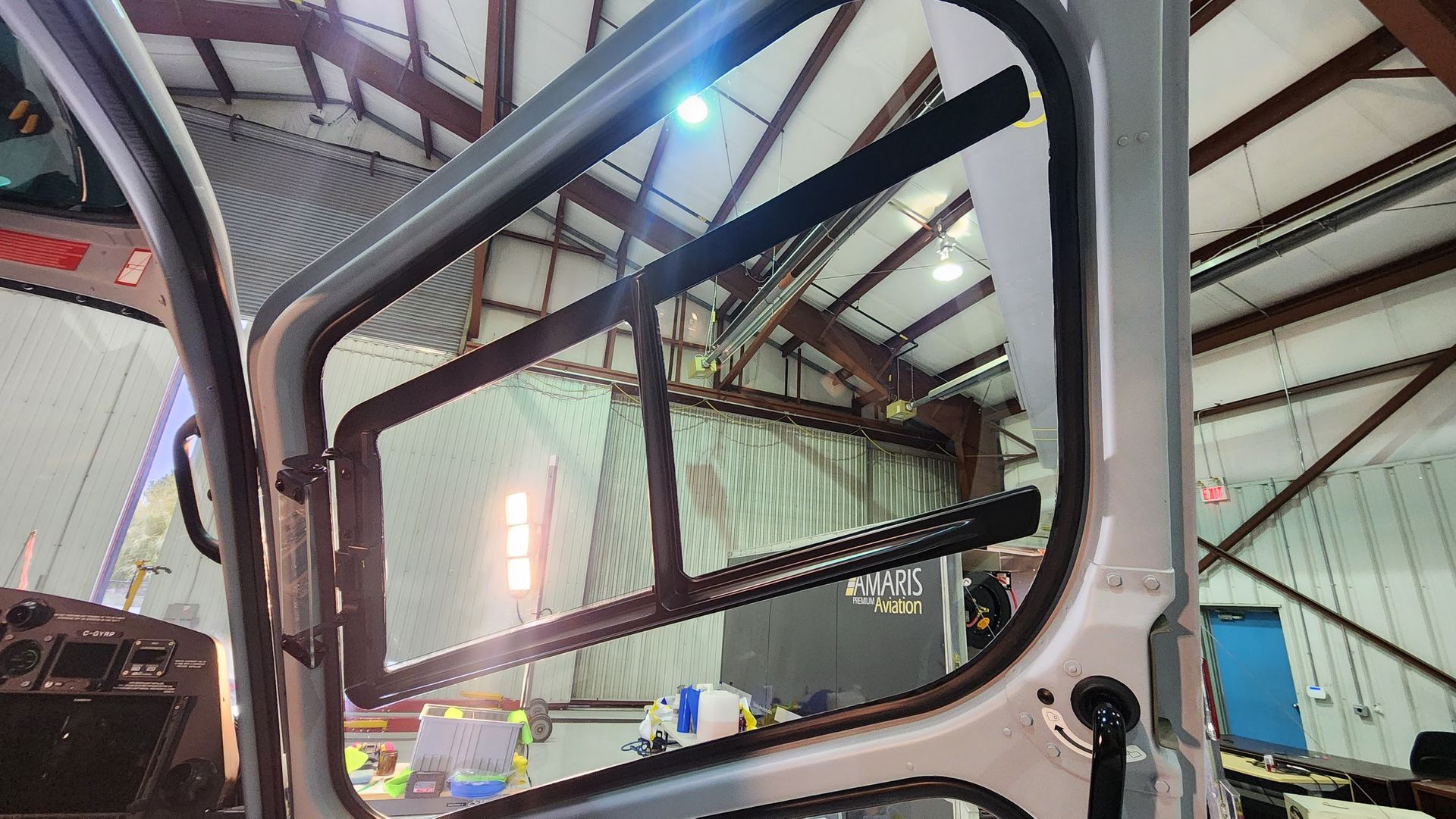 View from inside a vehicle's open door, looking at a building's interior.