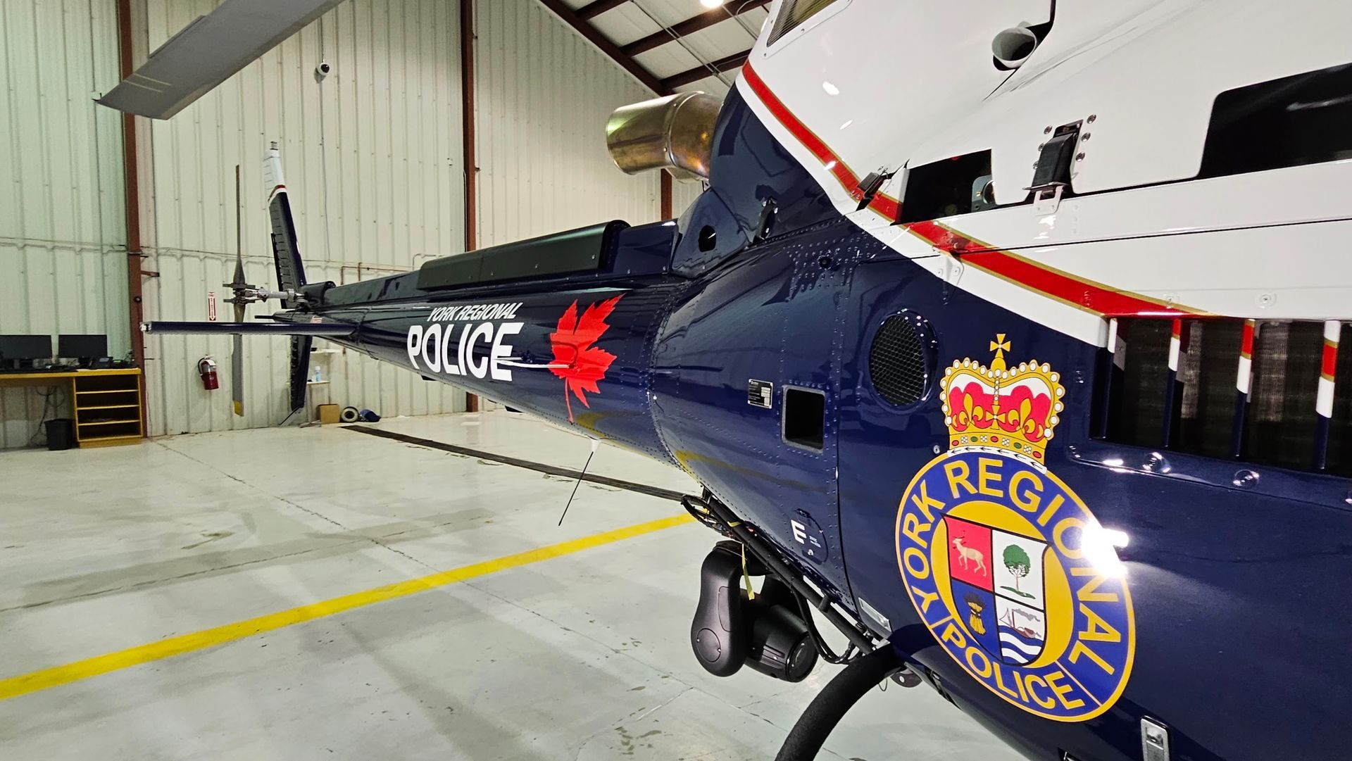 Blue York Regional Police helicopter in a hangar.