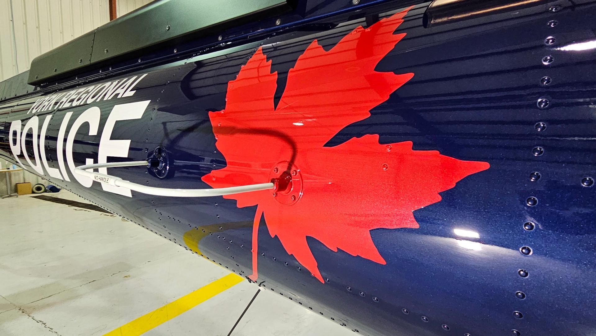 Blue helicopter with large red maple leaf and