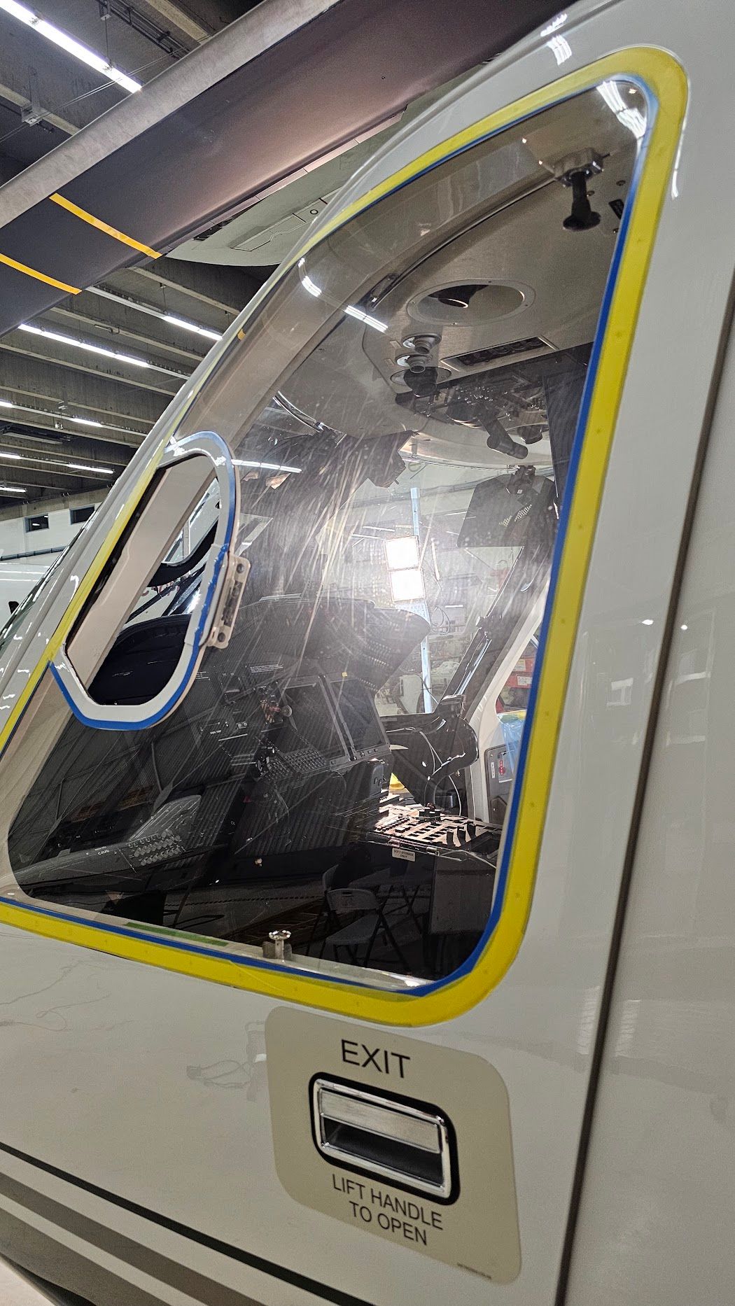 View of an aircraft cockpit window with a yellow frame and