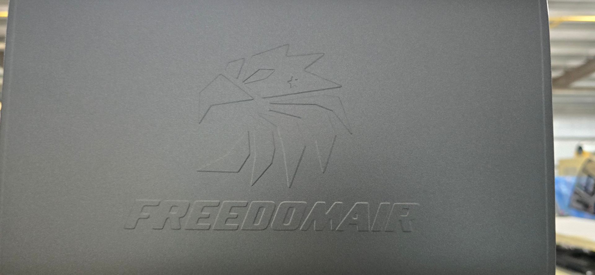 Dark gray panel with the FREEDOM AIR logo and an eagle design embossed on it.