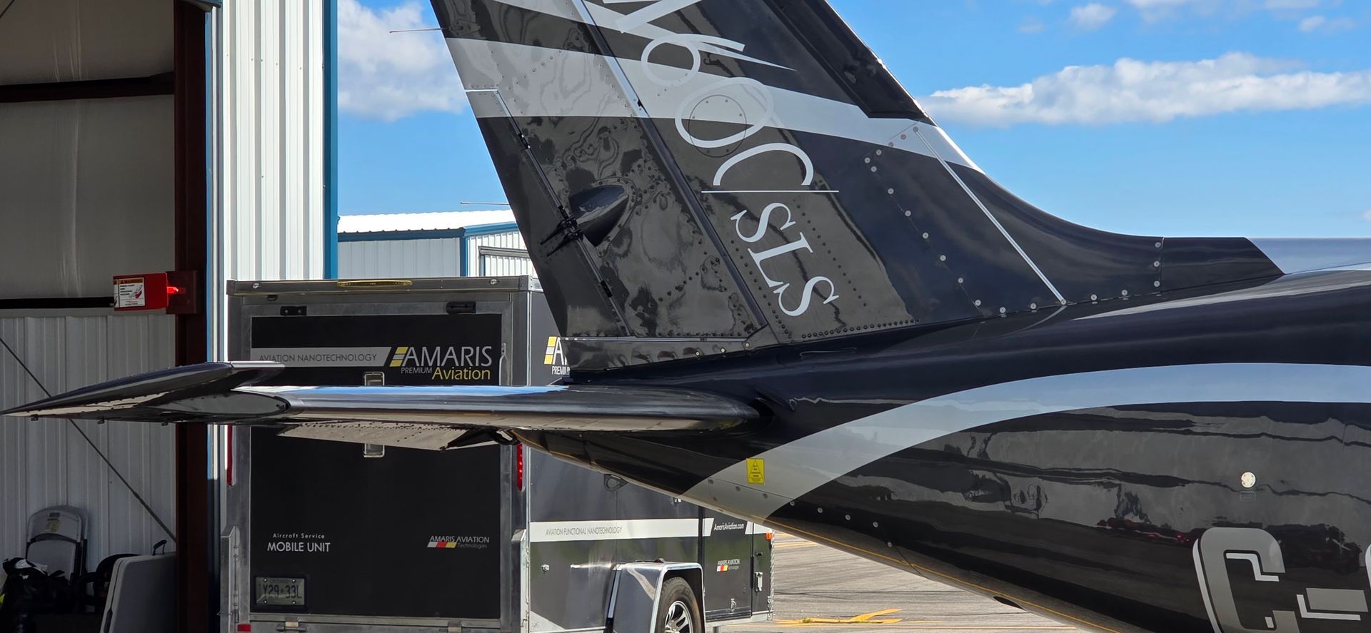 Tail of a black and silver private plane with the text