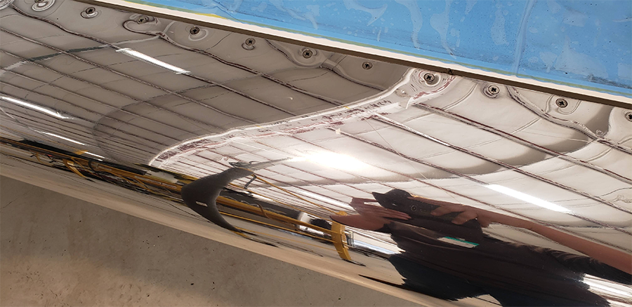 Inside of a boat, showing canvas and a person's arm.