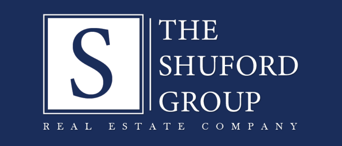 Logo for The Shuford Group Real Estate Company with a large blue “S” and white text