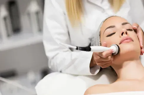 A woman is getting a facial treatment at a beauty salon.