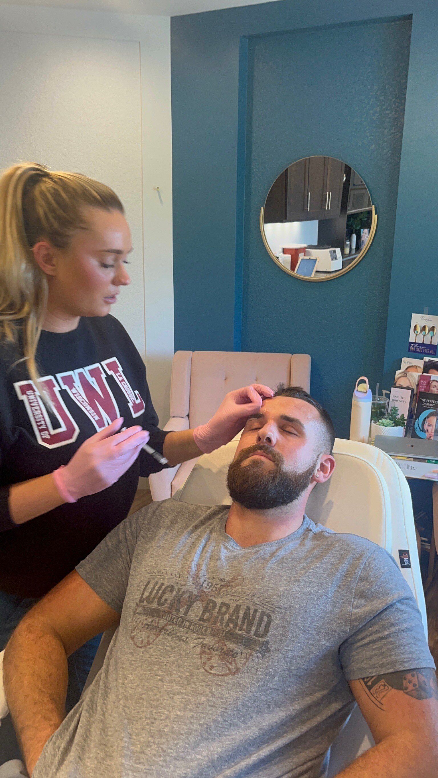 A person receiving an injection above the eyebrow from a medical professional. Interior shot.
