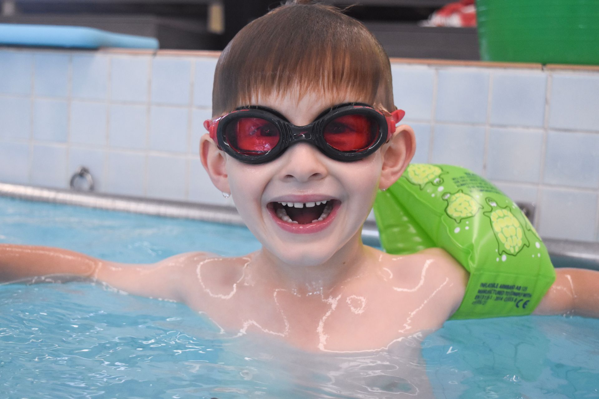 boy wearing goggles in pool