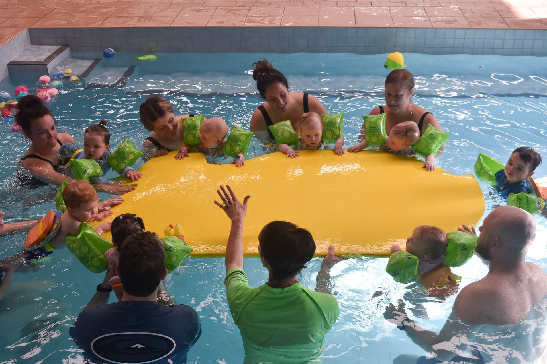 A group of people are playing in a swimming pool.