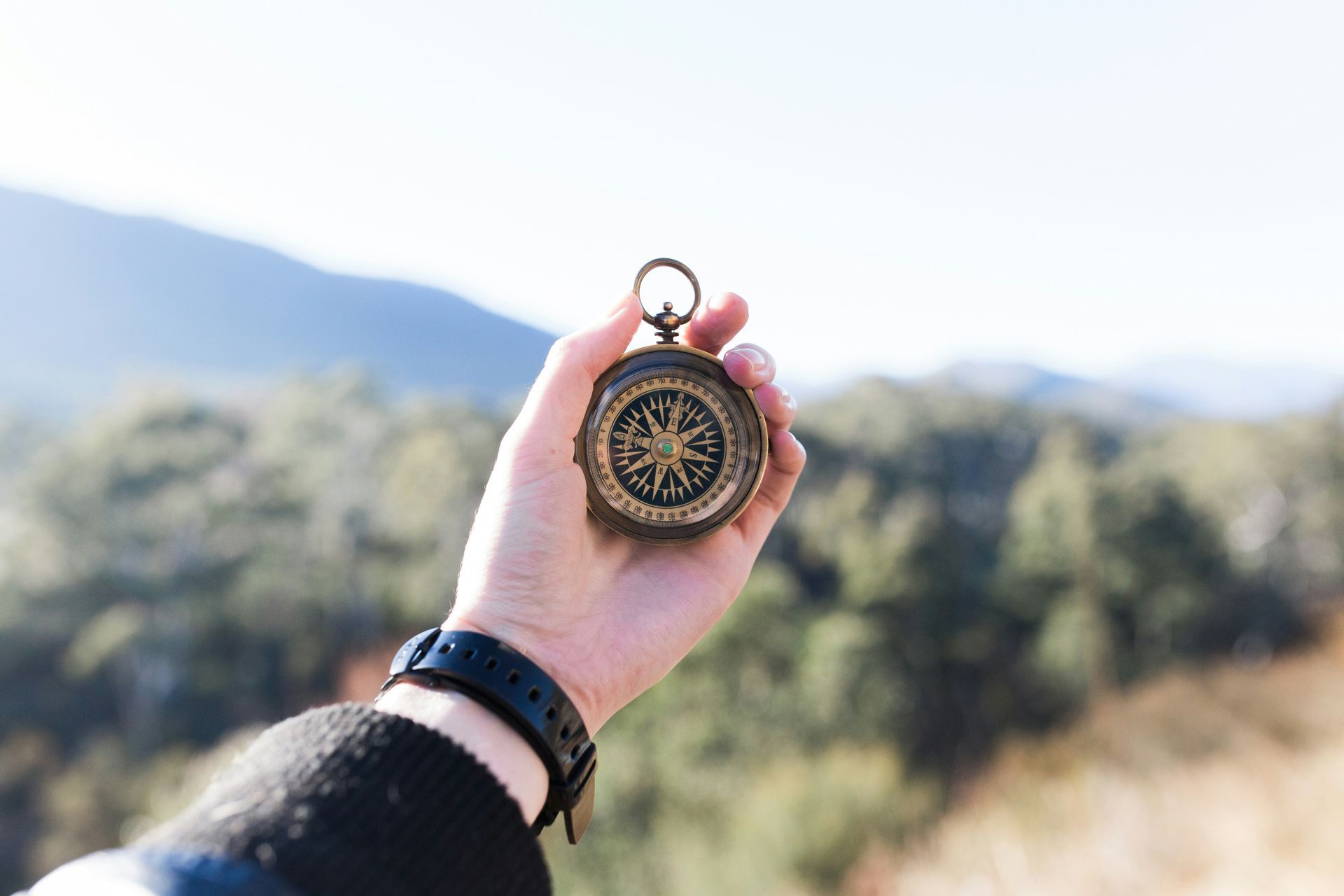 Photo of person holding a compass in their hand