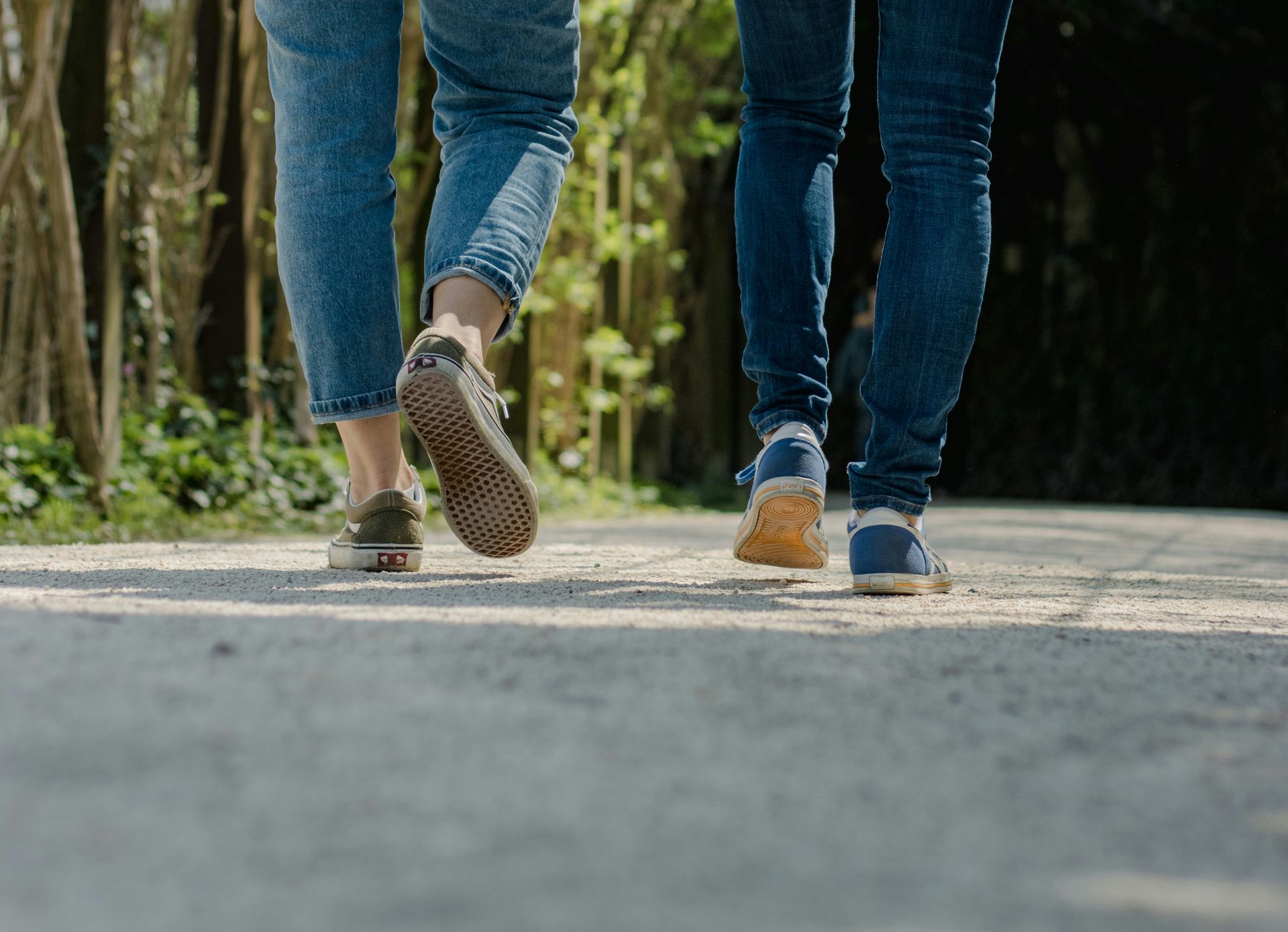 Two people walking down a path together 