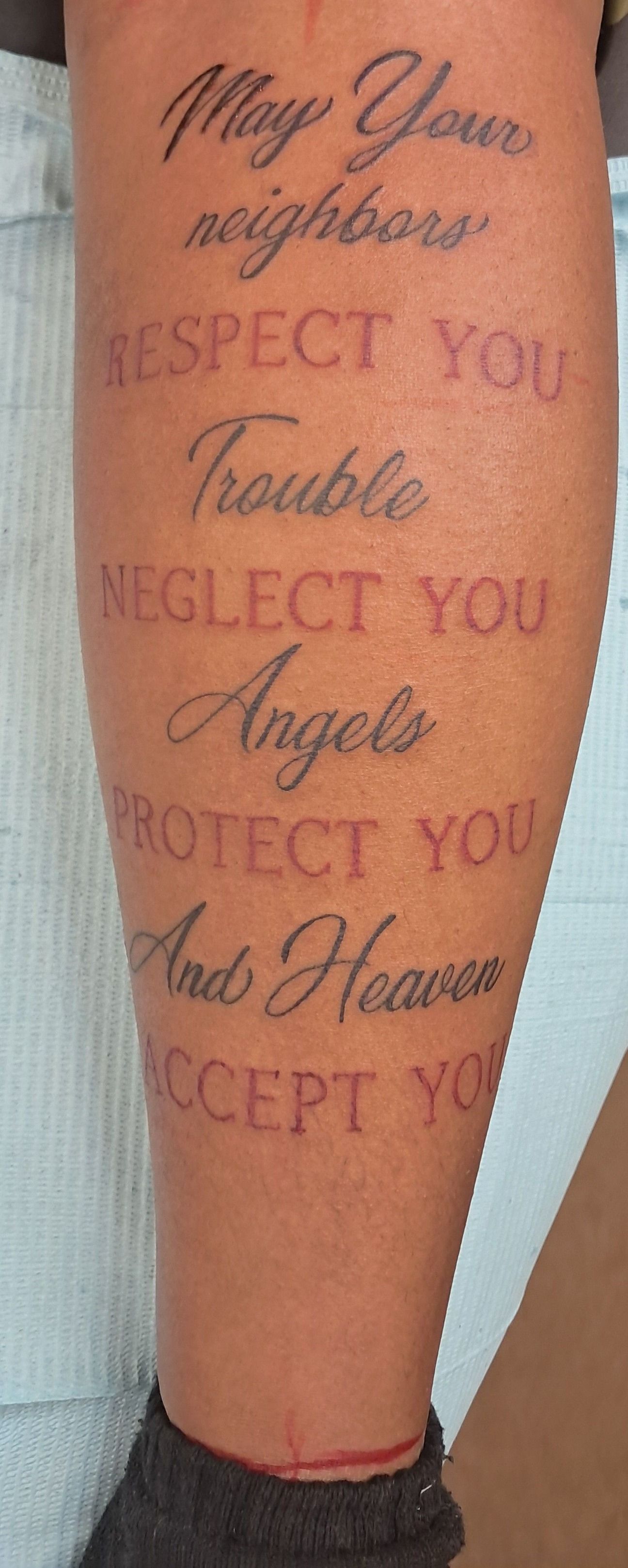 Tattoo on arm with the words: May Your neighbors respect you. Trouble neglect you. Angels protect you. And Heaven accept you.