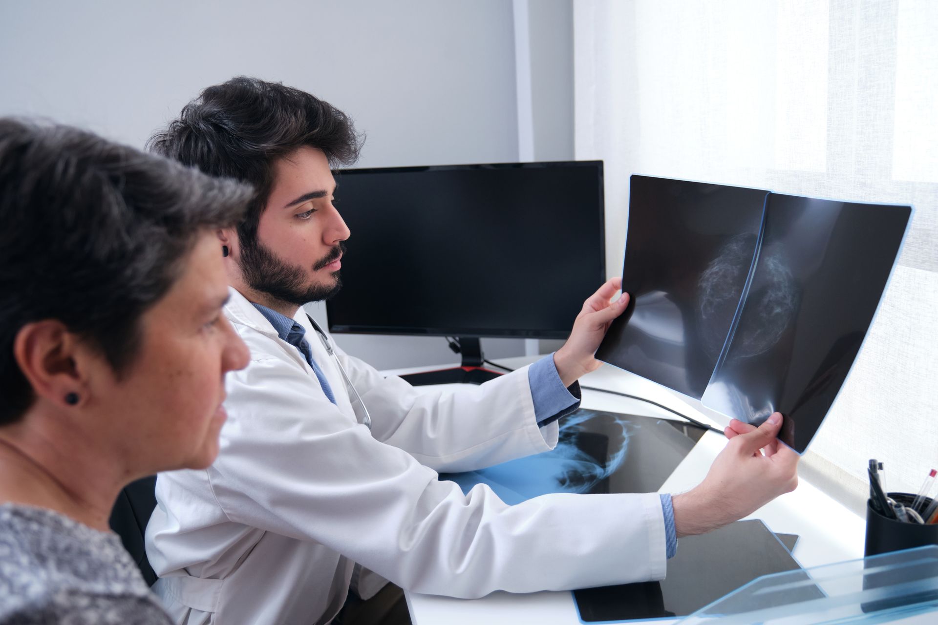 a-male-doctor-sits-at-his-desk