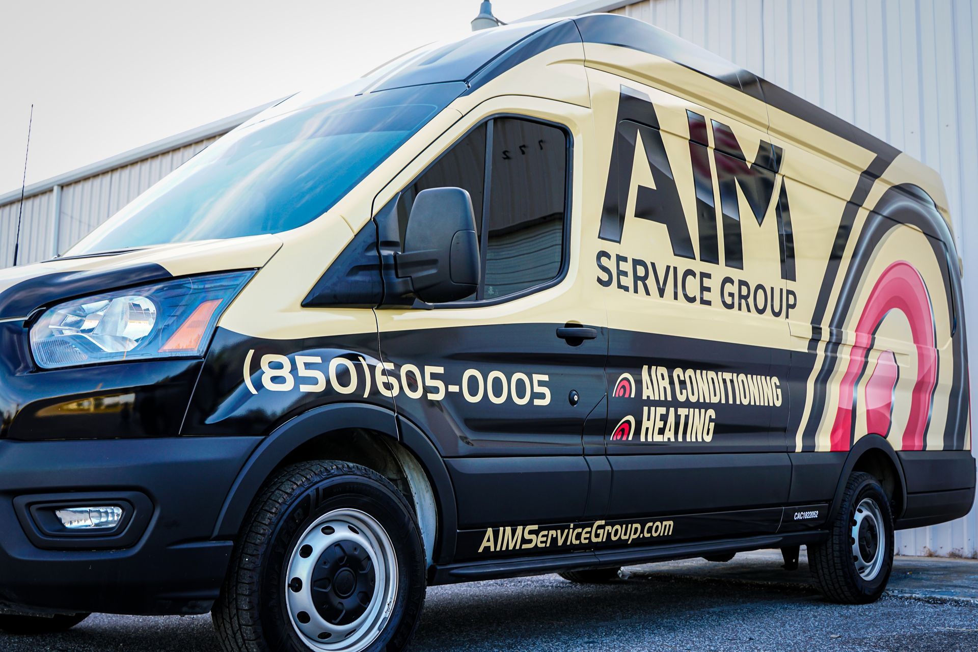 A service group van is parked in front of a building.