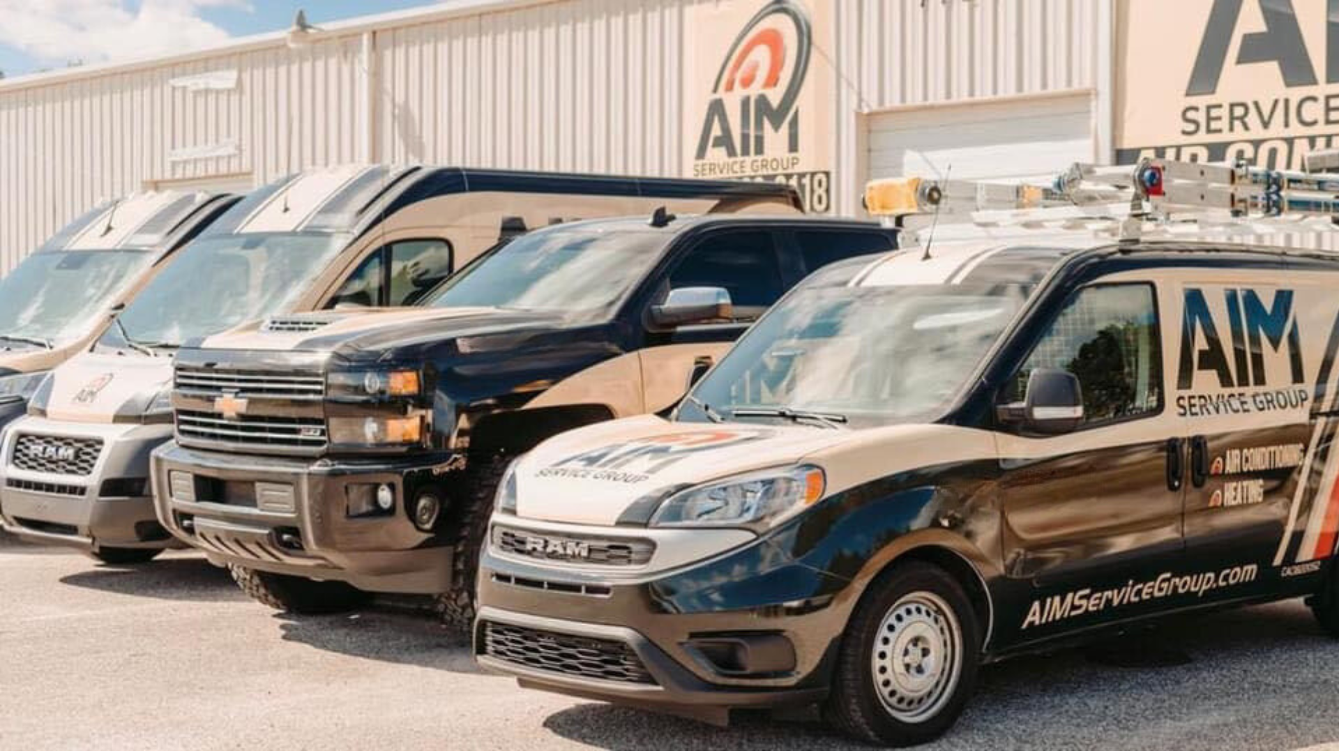 A row of vans parked in front of a building.