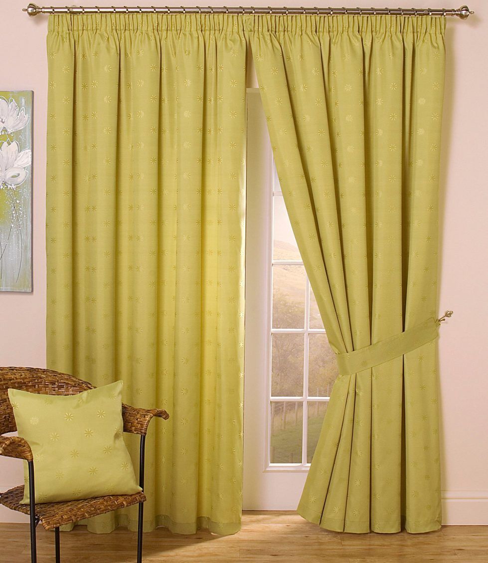 A room with yellow curtains and a chair