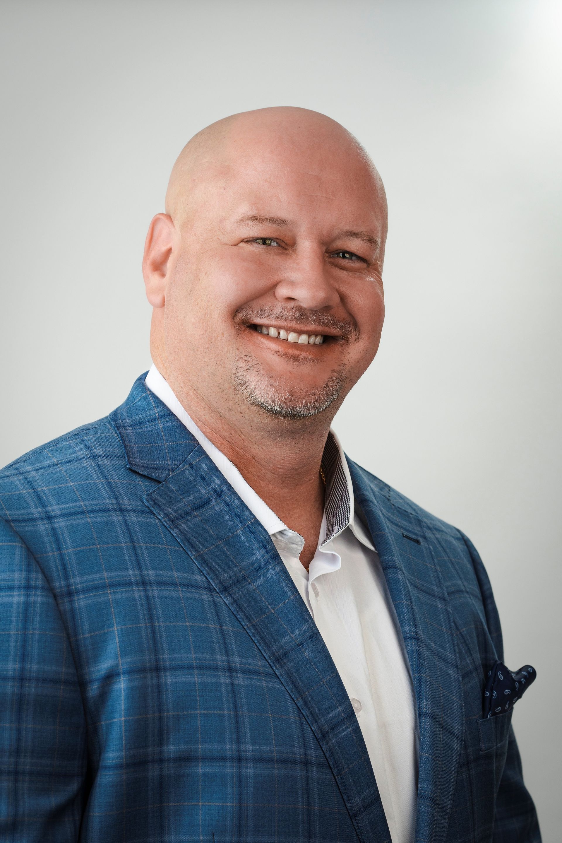 A man and a woman are sitting on a dock overlooking a lake.
