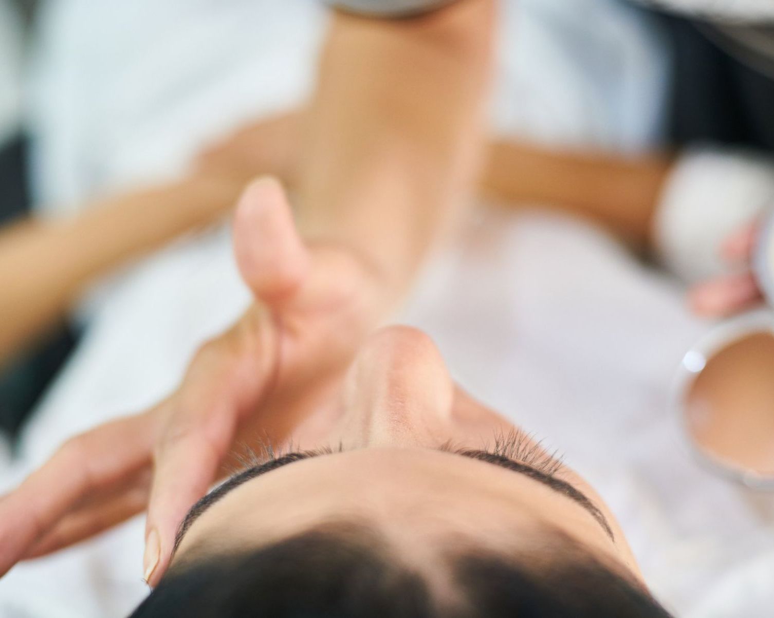A woman is getting a facial treatment at a beauty salon.