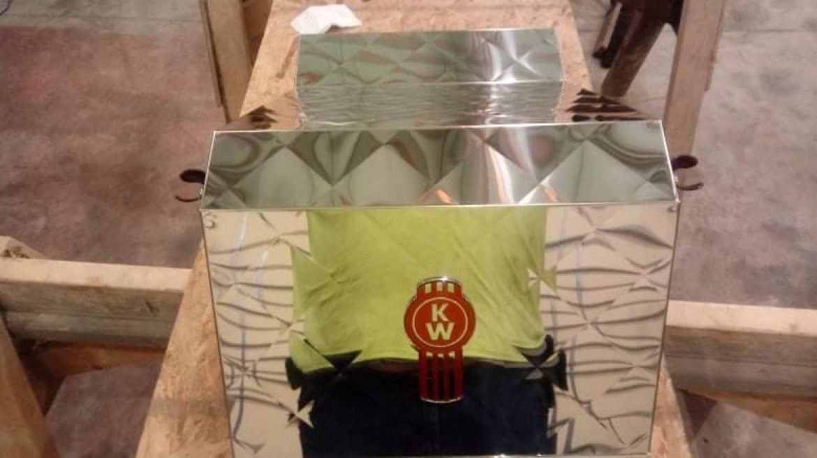 A stainless steel box with a k & w logo on it.