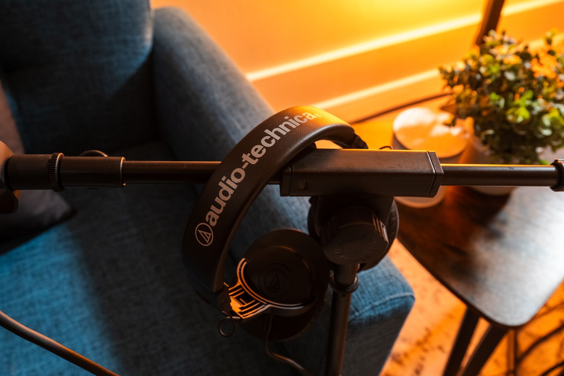 A pair of audio technica headphones sitting on a stand in the content studio