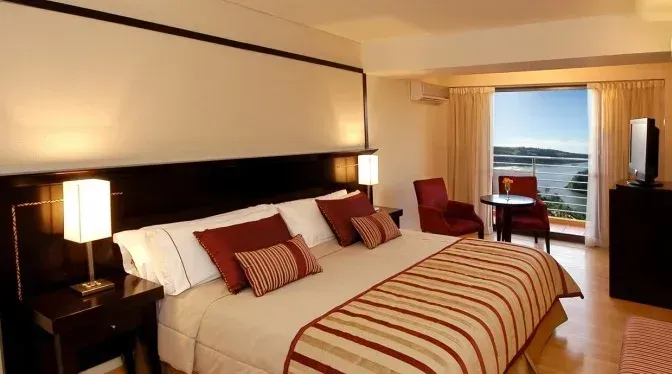 Una habitación de hotel con una cama grande y un televisor.