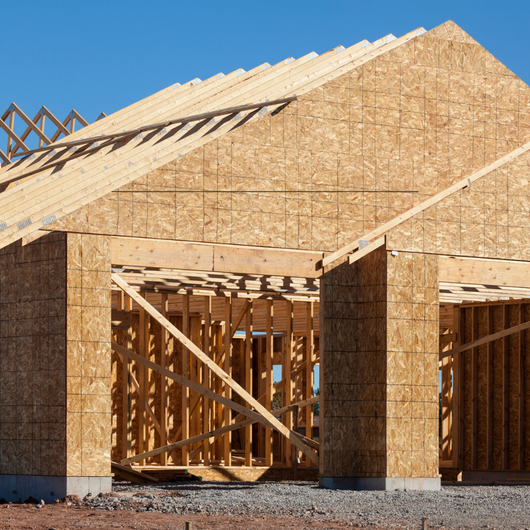 A house under construction with a blue sky in the background